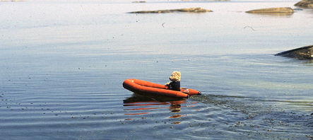 Inflatable boat in the sea Teddy Bear as captain